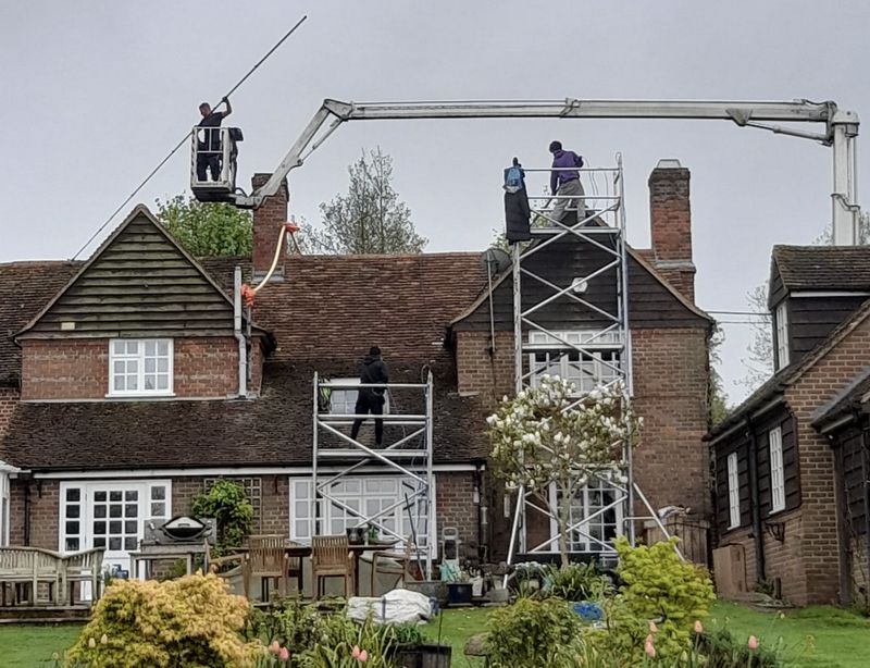 The Roof Moss Cleaners using cherry picker and scaffolding to clean roof safely and professionally in Wellesbourne, Warwickshire